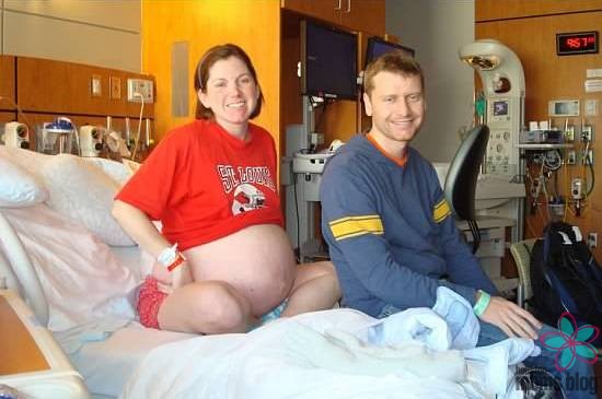 A pregnant woman and her husband on a hospital bed. Logo: Houston moms blog. 