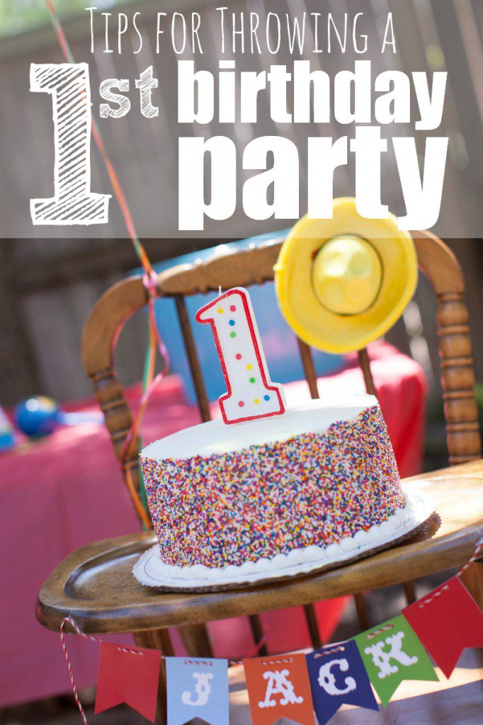 Tips for Throwing a First Birthday Party. A photograph of a cake with a number one candle set on a tray of a highchair. 