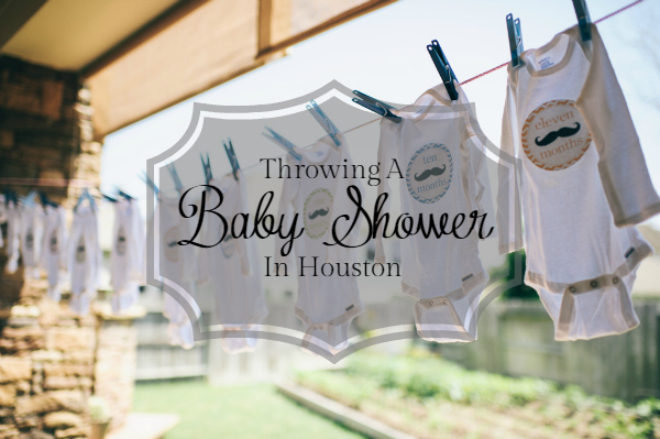 Throwing a baby shower in Houston. A photograph in the background of a row of onesies hanging from a clothesline.