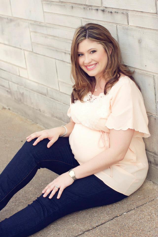 A pregnant woman posing for the camera. 