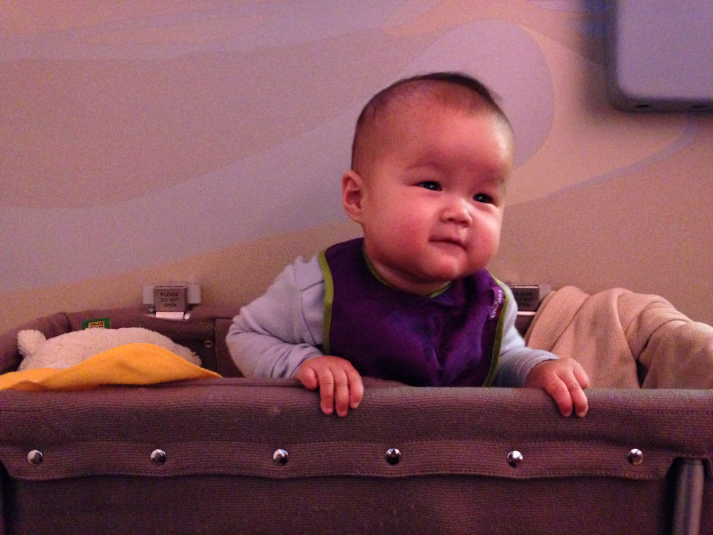 Kara having fun in her bulk head bassinet during our international flight to Dubai