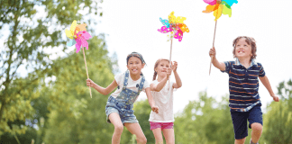 7 Ways You Have the Power to Prevent Child Abuse children in field holding pinwheels