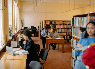 5 Secret Library Hacks {+ Bonus Digital Resources & Services Too!} people reading and working on computers at the library