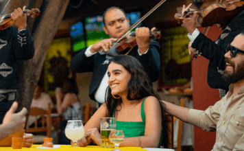 couple at Mexican restaurant is surrounded by mariachi band