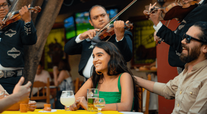 couple at Mexican restaurant is surrounded by mariachi band