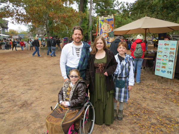 A family of four at a Renaissance festival. 