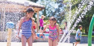 girl plays in splash pad