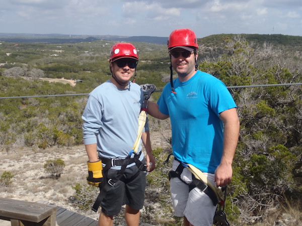 Two men wearing helmets and harnesses at Wimberley Zip Line.