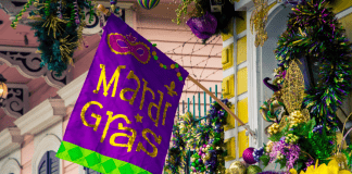 Mardi Gras flag hangs on home
