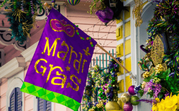Mardi Gras flag hangs on home