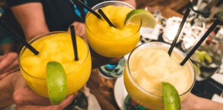 hands holding margarita glasses toast