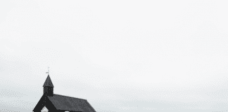 The Hypocrisy:: Sexism in the Evangelical Church A photograph of a church in an open field.