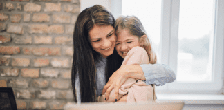 A mother hugging a child.