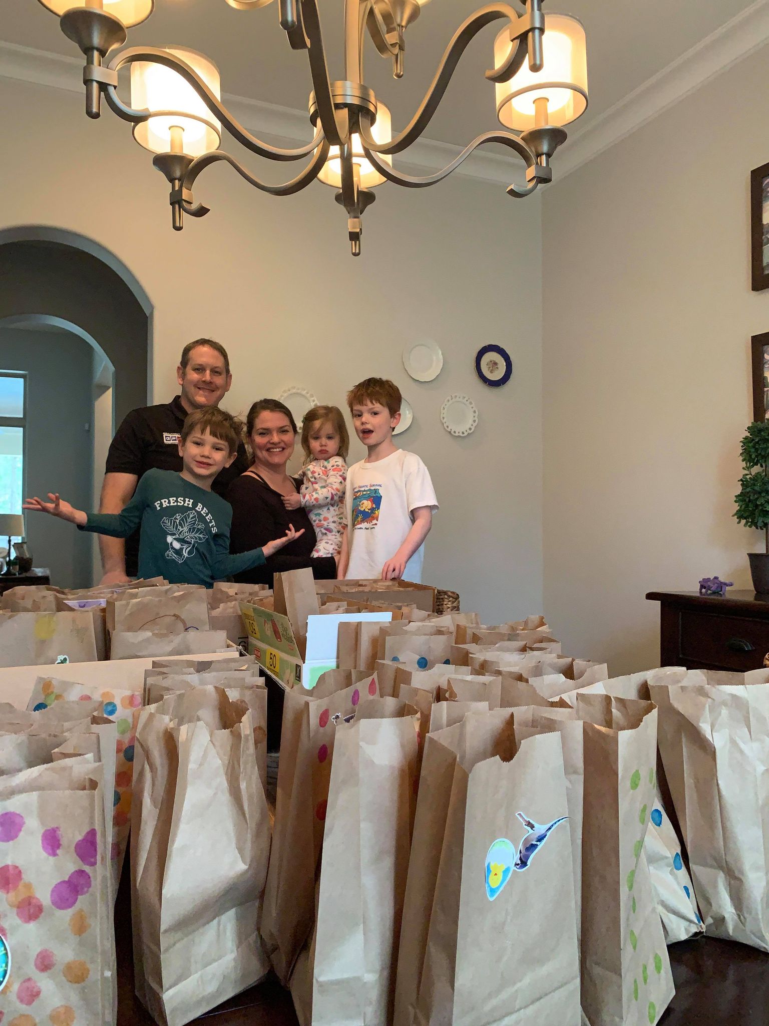 family packs lunches for kids in need
