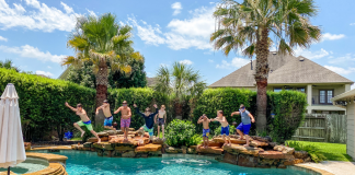 Ten Summer Play Date Ideas for Kids and Moms A photograph of 8 kids jumping into a backyard pool.