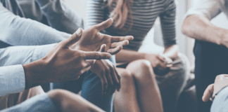 We Have to Keep Learning if We’re Going to Keep Arguing A group of people sitting in a circle having a discussion.