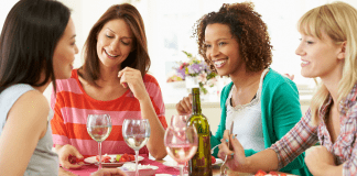 Celebrating National Girlfriends Day with Gratitude Four smiling women eating a meal together.