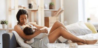 Embracing the Battle With Breastfeeding A woman breastfeeding a baby.