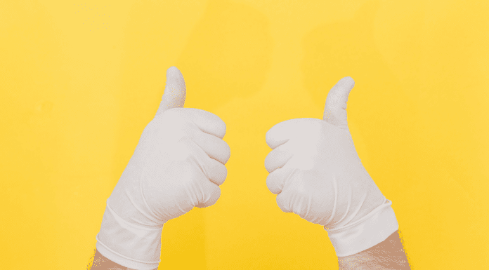 Gloved hands both giving a thumbs up.