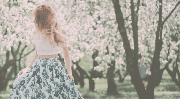 MLM Culture: Feminism and the Myth of Having it All A woman in a grove of flowering trees.