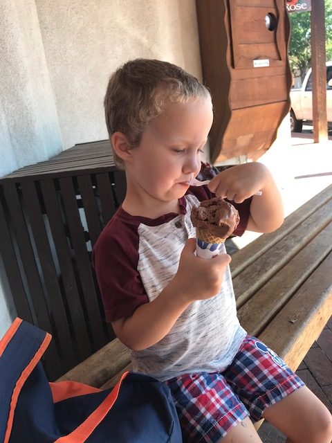 A young boy eating an ice cream. 