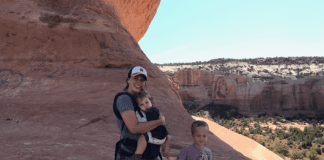 3 Things I Learned from Road Tripping Solo with My Kids A photograph of a mother holding a young girl and standing next to a young boy at a national park.