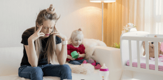 The Pursuit of Perfection: How Not to Be a Martyr of Motherhood A stressed mother sitting next to a young child.