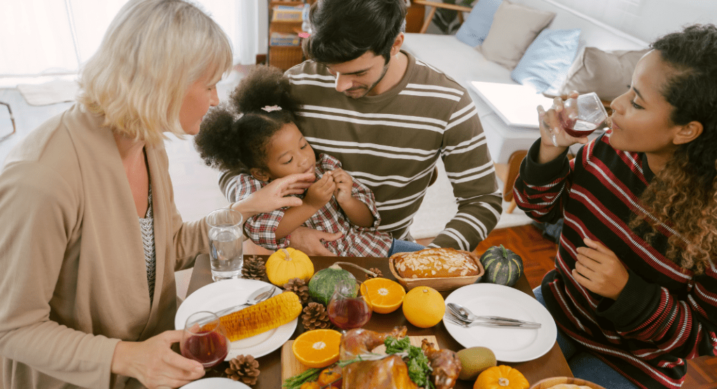 Family of four gathered around the table after making Thanksgiving recipes