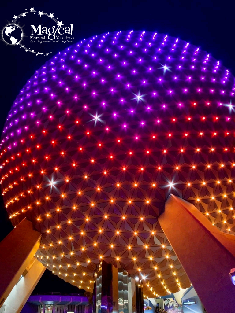 Epcot ball lit up at night 