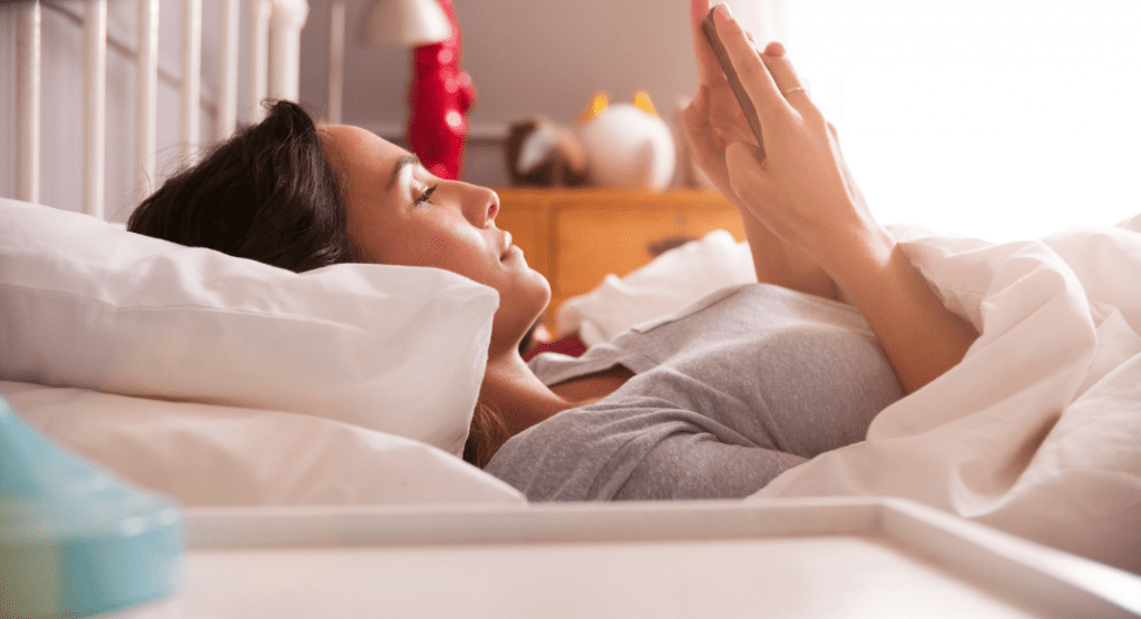 woman caught in revenge bedtime procrastination by scrolling phone in bed