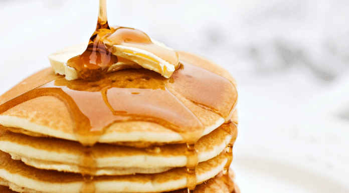 Celebrate National Pancake Day in Houston stack of pancakes with butter and syrup on top