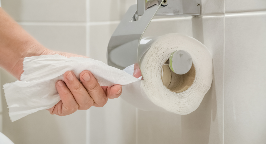 hand grabbing toilet paper off roll