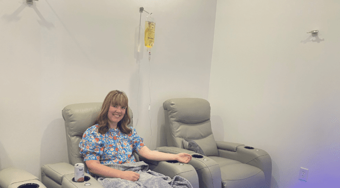 Let’s Make it Through May: How IV Therapy Can Benefit Busy Moms woman sits in chair receiving IV therapy
