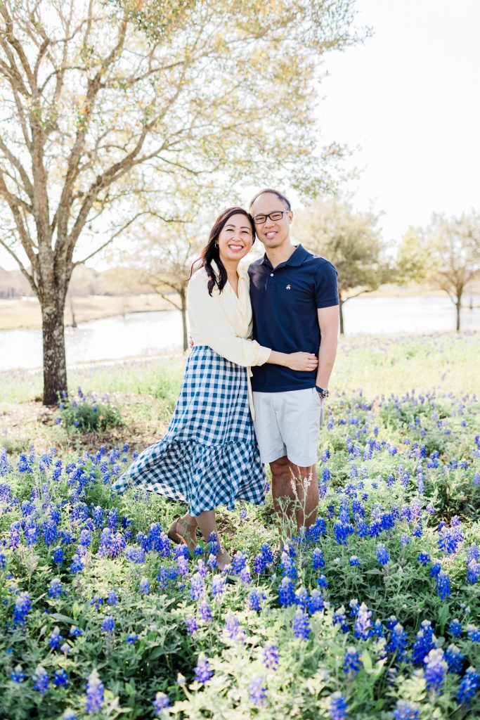 couple poses in field of bluebonnets