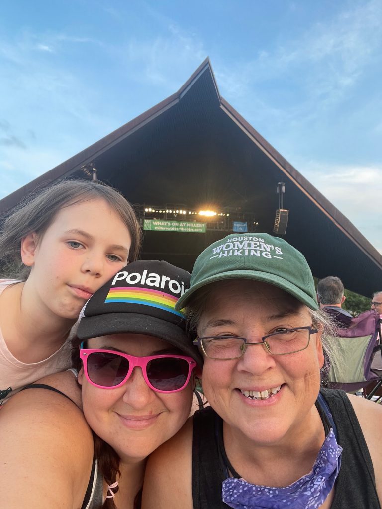 family enjoys a performance at Miller Outdoor Theatre