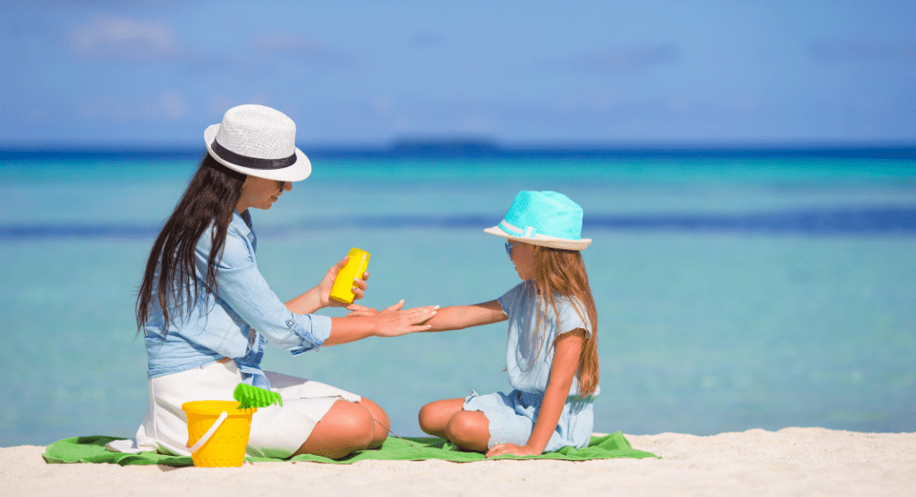 woman applying sunscreen to child