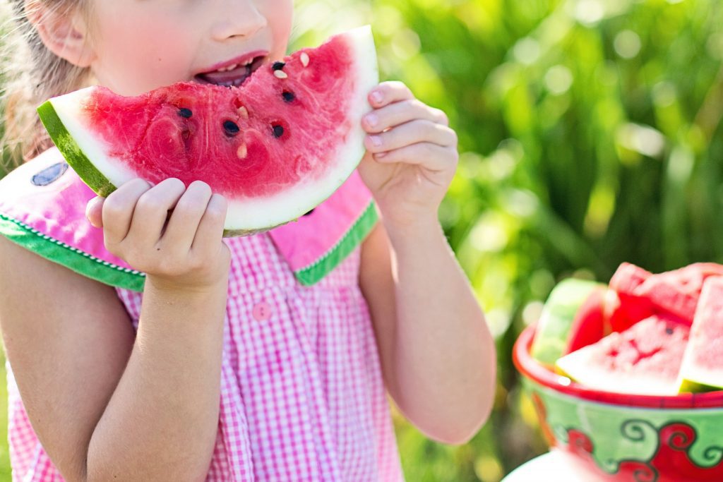 young girl eating watermelon