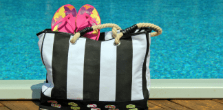 Pool Bag Essentials {+ The BEST Sunscreens} striped pool bag with flip flops sticking out
