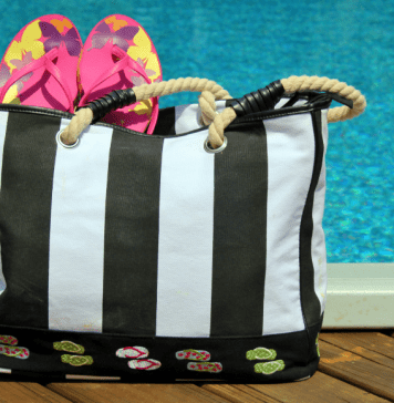 striped pool bag with flip flops sticking out