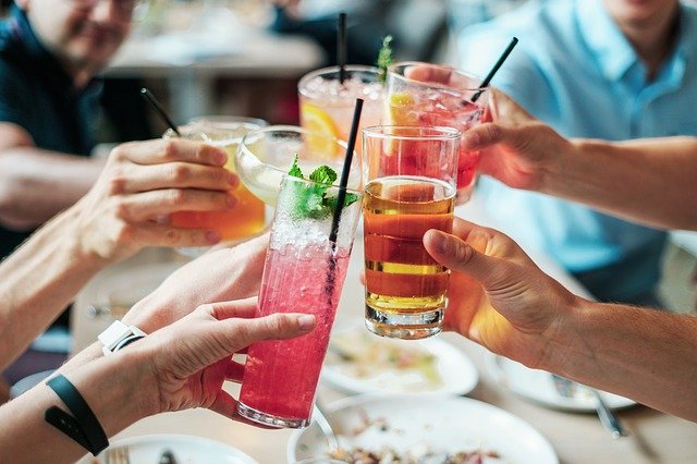 group toasting with cocktails