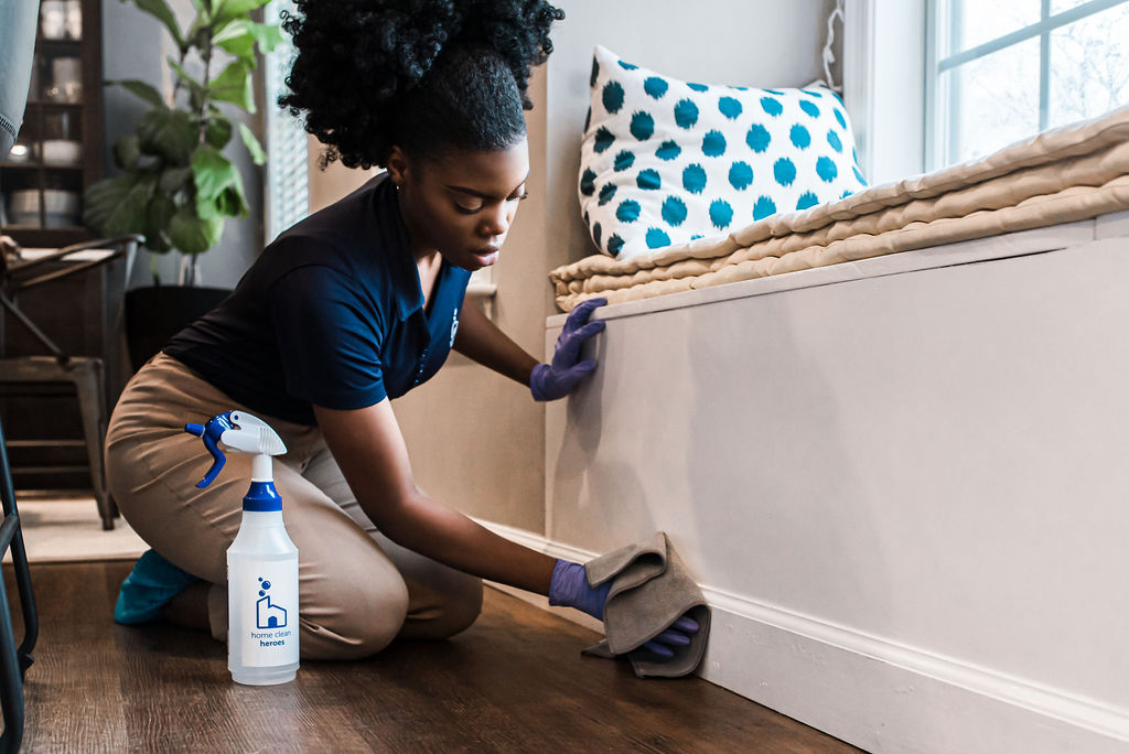 woman cleans baseboards
