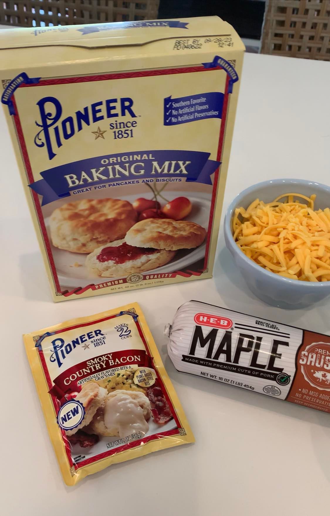 Pioneer baking mix, bowl of cheese, gravy packet, and sausage packet