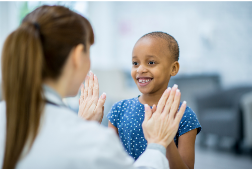 young girl touches hands with doctor