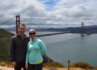 couple poses in front of Golden Gate Bridge