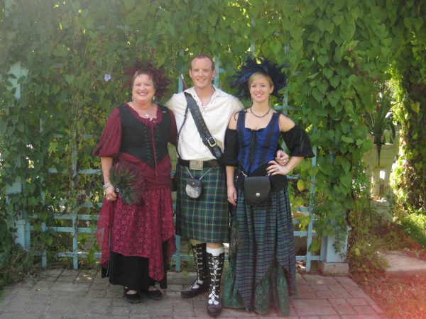 3 adults dressed for the Texas Renaissance Festival