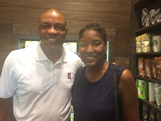 woman stands in Starbucks with Isaiah Thomas