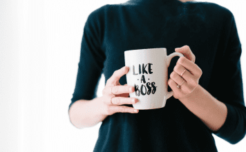 woman holding mug that says "Like a Boss"