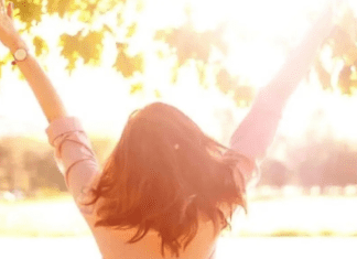 Let Mayanah Financial Help you Live Debt Free woman outside with hands in the air