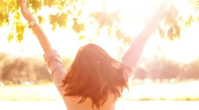 Let Mayanah Financial Help you Live Debt Free woman outside with hands in the air