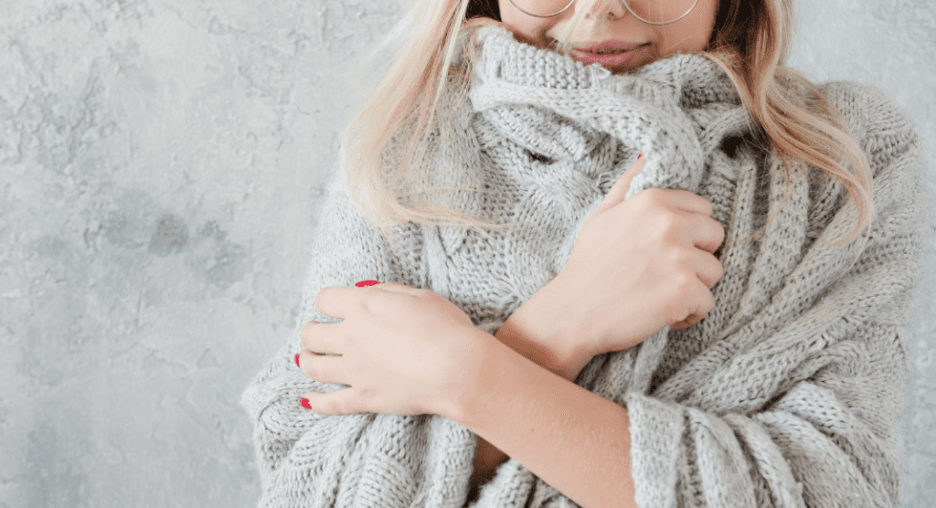 woman snuggles cozy sweater